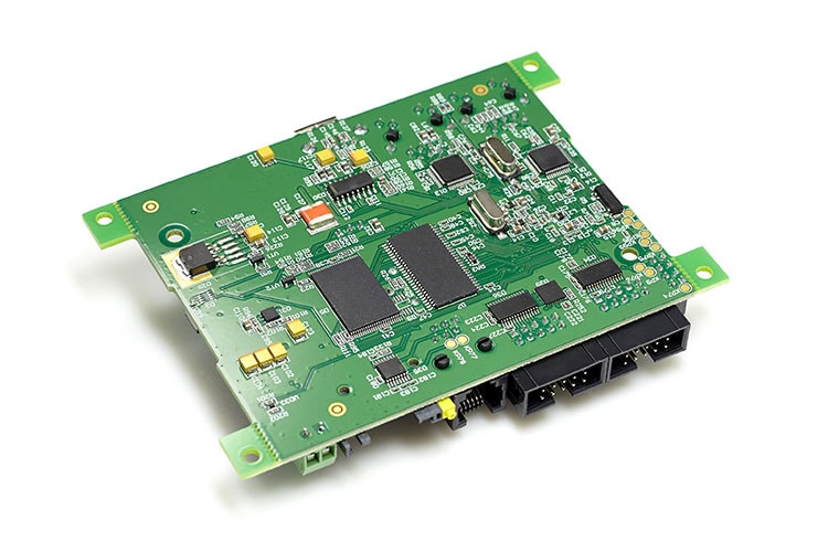 Electronic printed circuit board with chips and other components, green color, back side, angled view