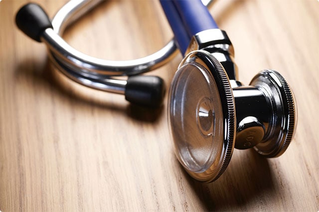 stethoscope on a wooden surface