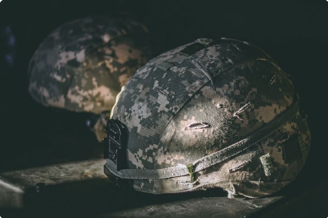 Universal Camouflage Pattern helmets on a table